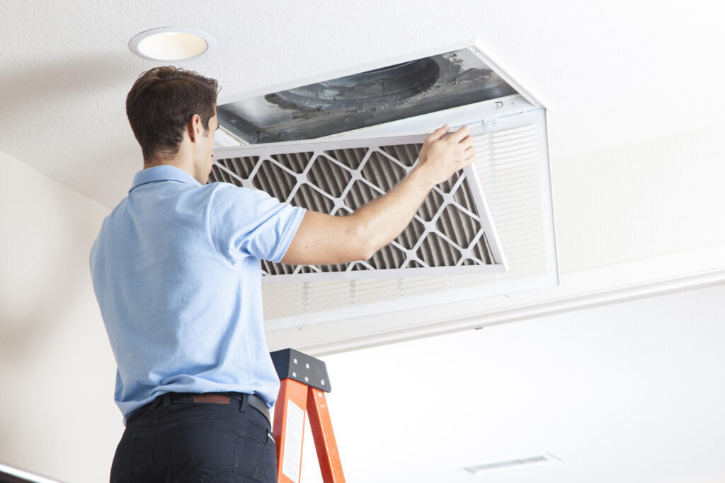 man changing air filter