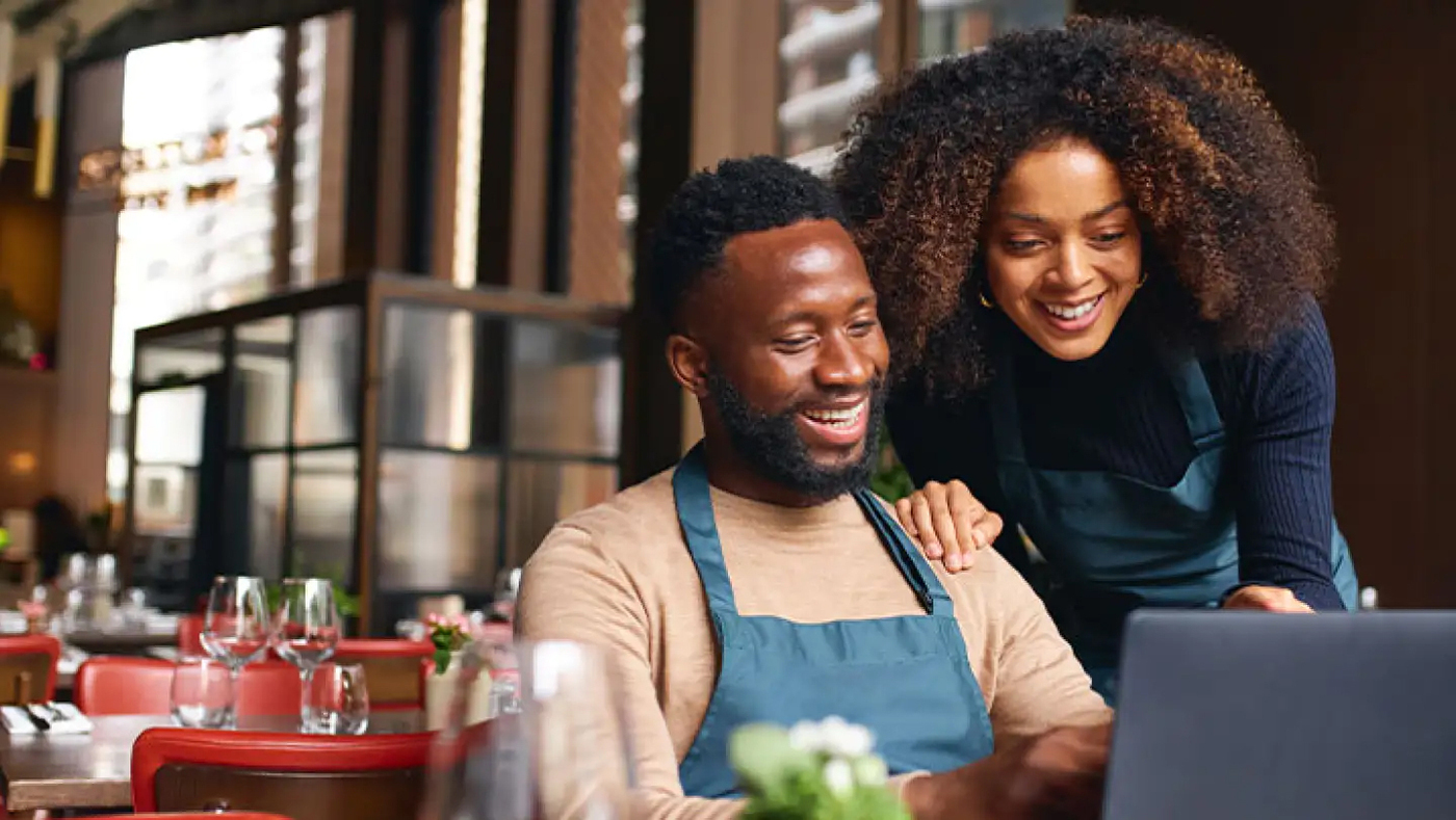 Couple looking at computer together smiling