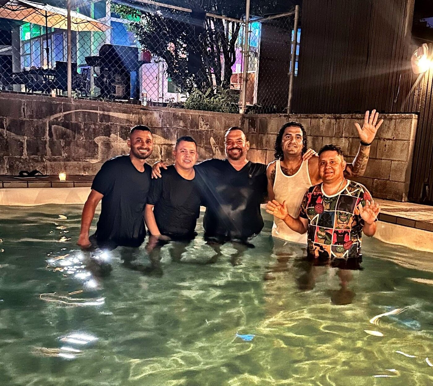 A group of men standing in a pool AI-generated content may be incorrect.