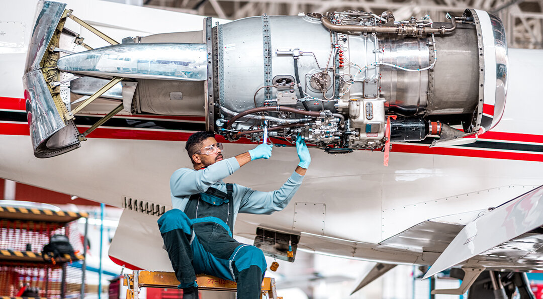 aircraft engineer working on jet engine