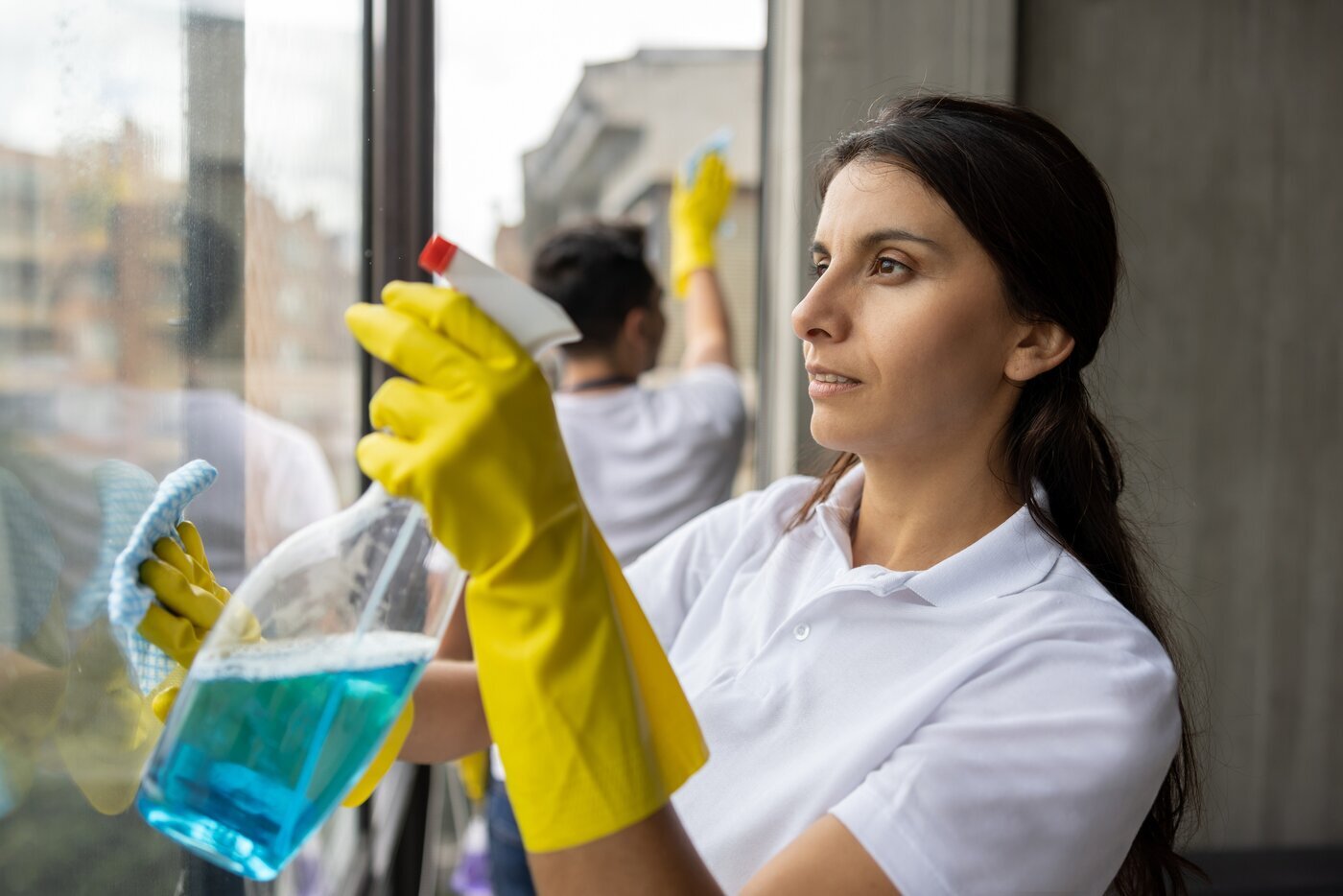 woman cleaning a window