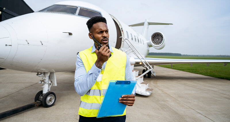 ground crew using walkie-talkie on airport tarmac
