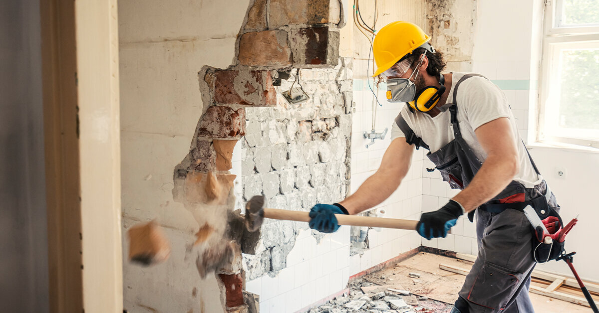 a man demolishing a wall