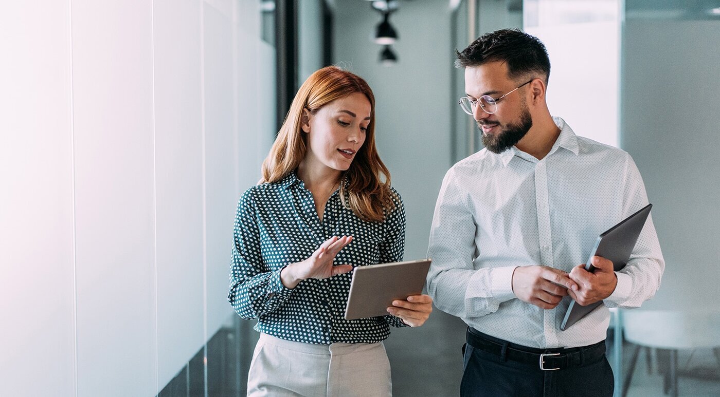 Co-workers discussing results looking at a tablet