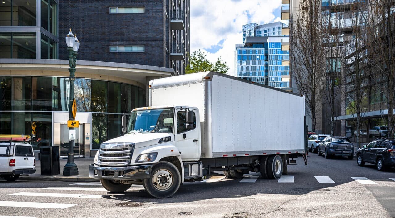 box truck traveling through city