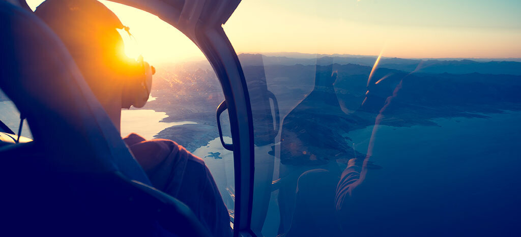 aircraft flying at sunset