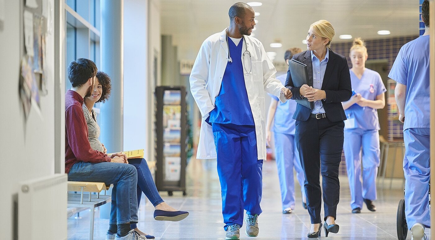 doctor speaks with a businesswoman