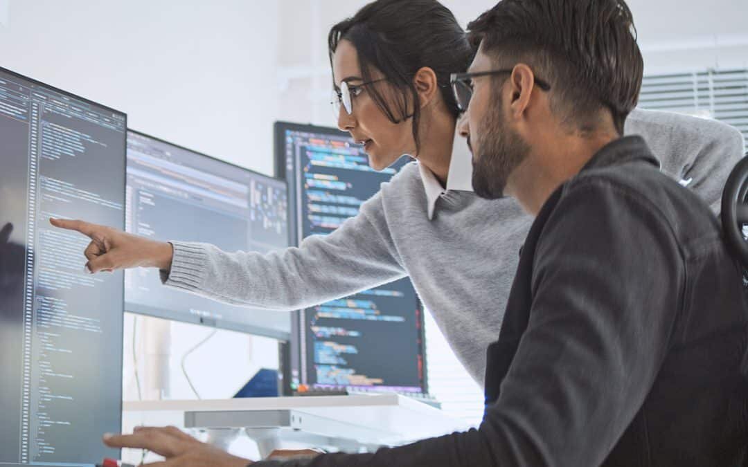 software engineer and developer work on program coding together