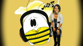 Myreah Eley in front of her company's banner